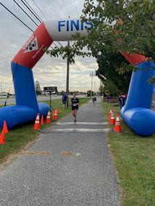 Woman crossing the finish line at a 5k
