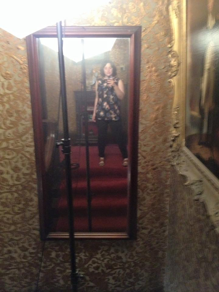 A selfie taken in a moment of rest in between shooting at the Gibson House. Between the lights, carpet, and insulating wallpaper, it was a very hot stairway.