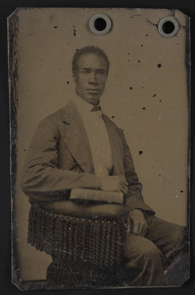 Portrait of a man seated in a posing chair