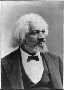 Photographic portrait of Frederick Douglass, seen from the mid-chest up, wearing a suit