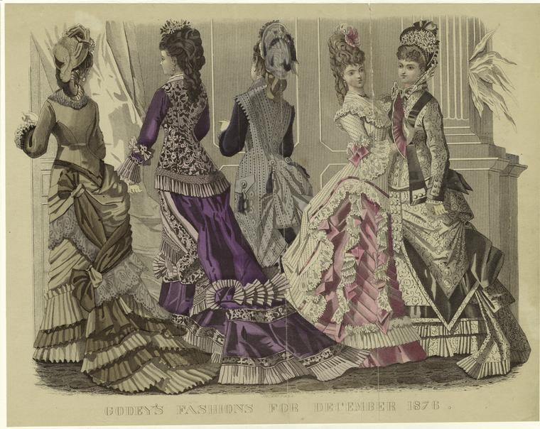 1870s fashion print depicting five women wearing silk dresses with large bustles and frilly decorations.