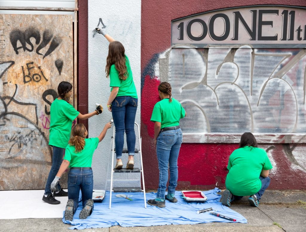 Volunteers painting building