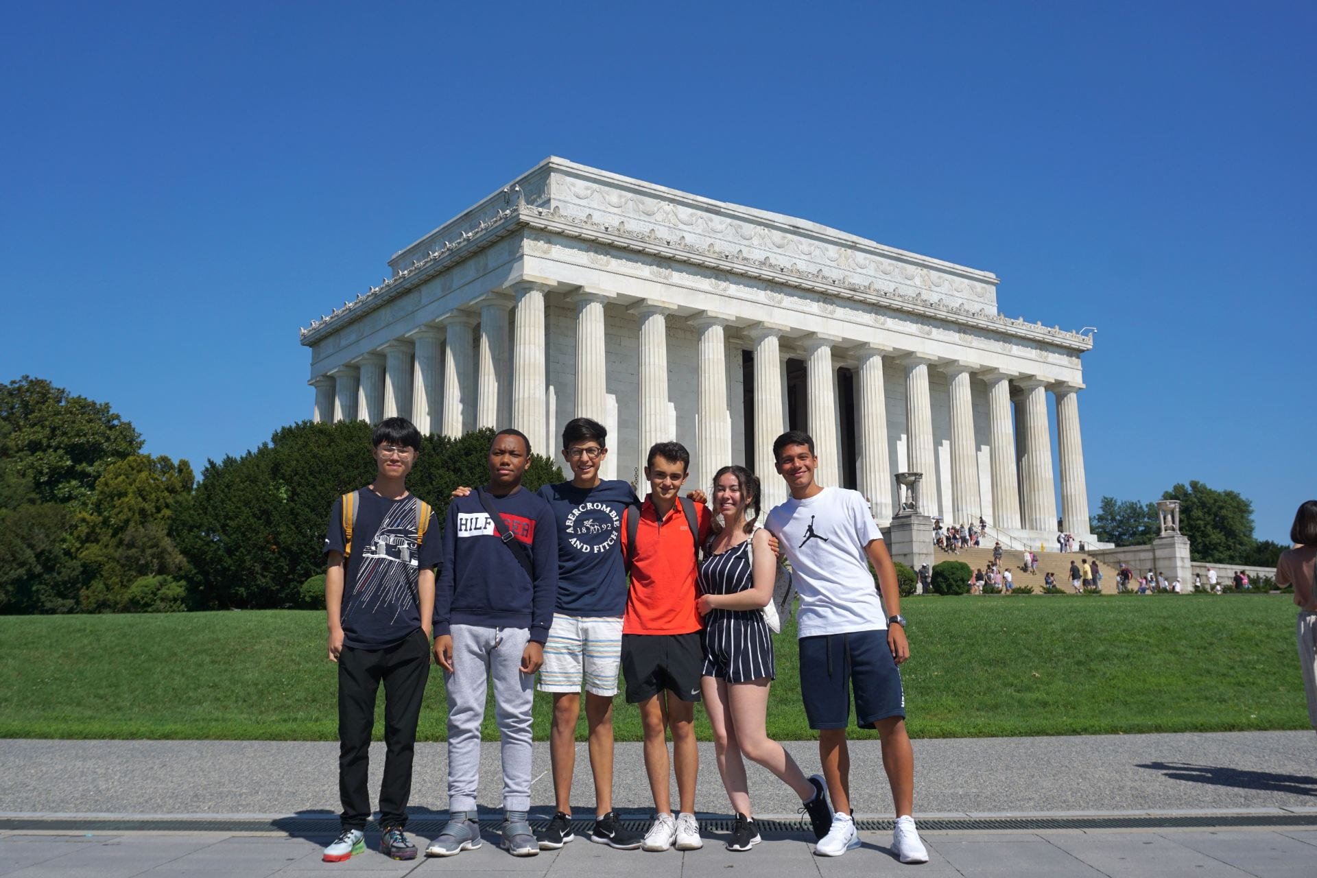 A group of Language Adventure students pose in front of the Lincoln Memorial in Washington, D.C.