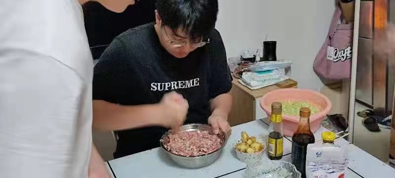 Student mixes dumpling filling