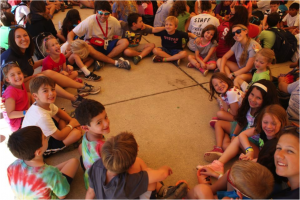 My co-counselors, campers, and I sitting in a circle during our weekly song session. 