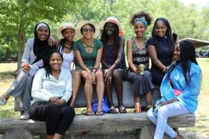 UD Mandela Fellows sit atop a picnic table at Lums Pond State Park for a group photo