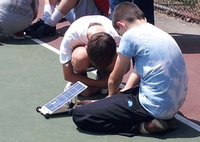 Two students working with a solar panel