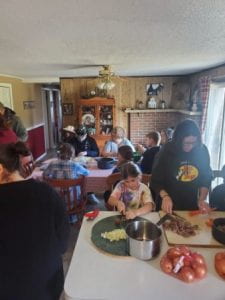 4-H members cooking soup and working on encouragement baskets