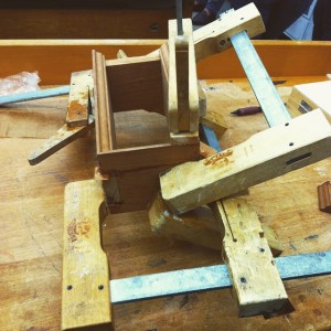 A glued box rests in clamps while the glue sets.