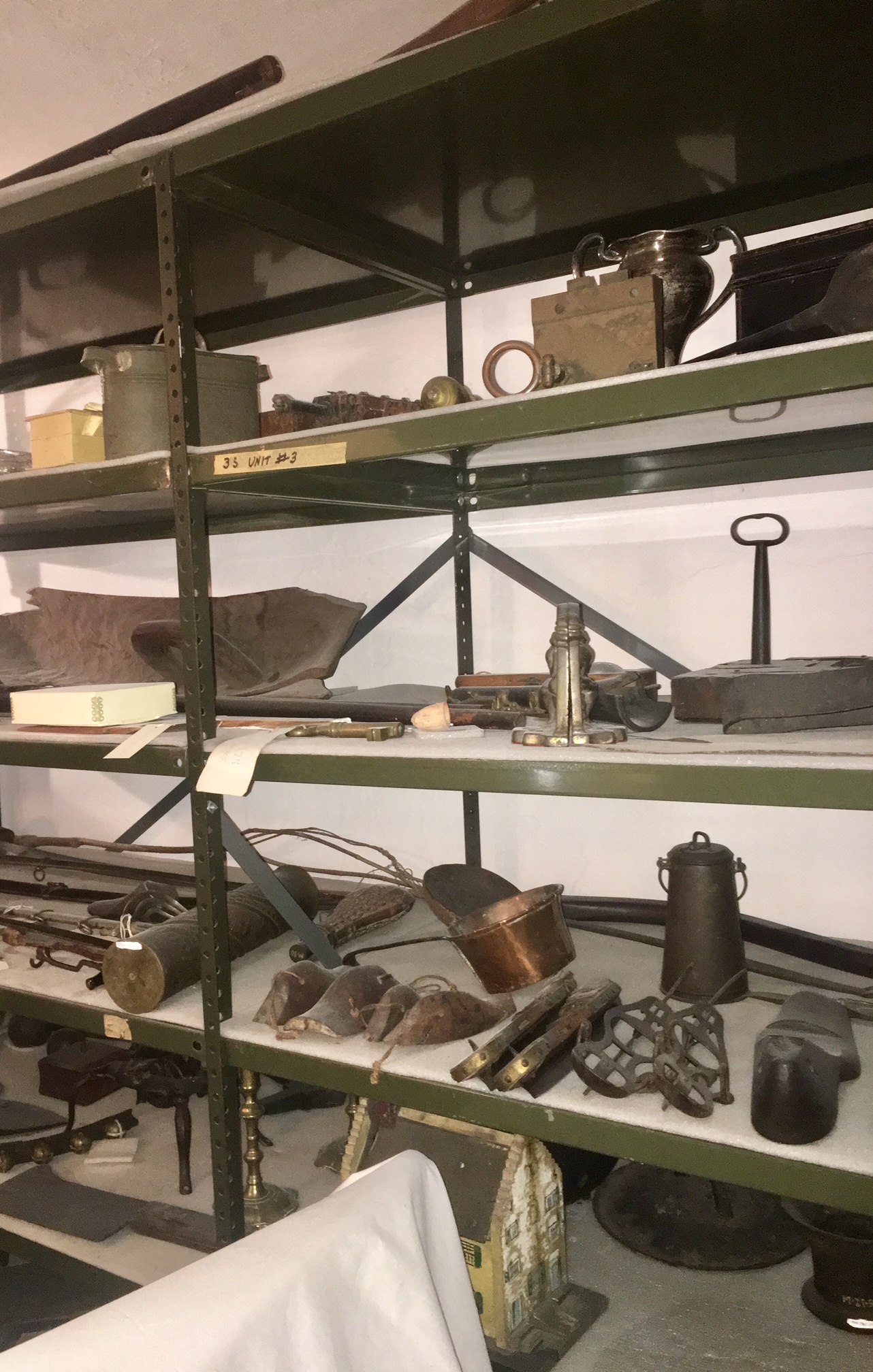 Various tools line a set of metal shelves