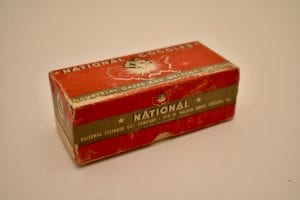 image of small red rectangular box with black and white labeling that reads “National Goggles – Industrial Gases and Welding Supplies; National Cylinder Gas Company, 205 W. Wacker Drive, Chicago, Ill.”