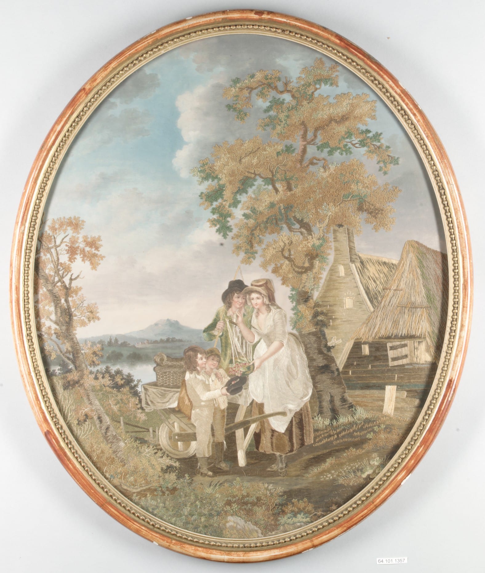 This oval embroidery shows a woman with a scale overflowing with cherries, two young boys holding out a hat filled with cherries, and a man with a whip standing behind the woman’s shoulder and gazing amorously at her face. They are in a pastoral landscape with a mountain and lake in the far background and a house and barn with thatched roofs in the nearer background. 