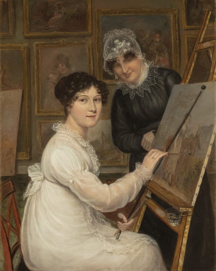 A woman in white sits at an easel and paints a woman standing in front of a horse. A woman in black watches the woman in white paint. The wall behind them is covered with paintings in gold frames.