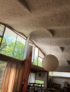 A photograph of the curved white cement ceiling in the Nakashima living room turned gallery