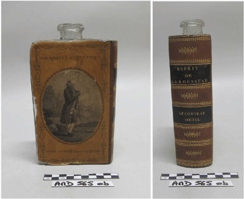 Back of glass flask covered with brown paper to imitate the back cover of a back with a print of Rousseau in the center; Brown and Black imitation leather made to look like the spine of a book with gold gilt decoration and the text, “Esprit de Rousseau” and “Le Contrat Social.”