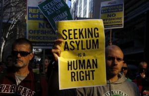 Protesters holding sign: "Seeking Asylum is a Human Right."