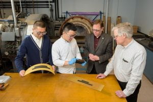 Left to right, Hongbo Dai, Hao Liu, Erik Thostenson and Will Johnson check out infrastructure sensors at UD’s Center for Composite Materials.