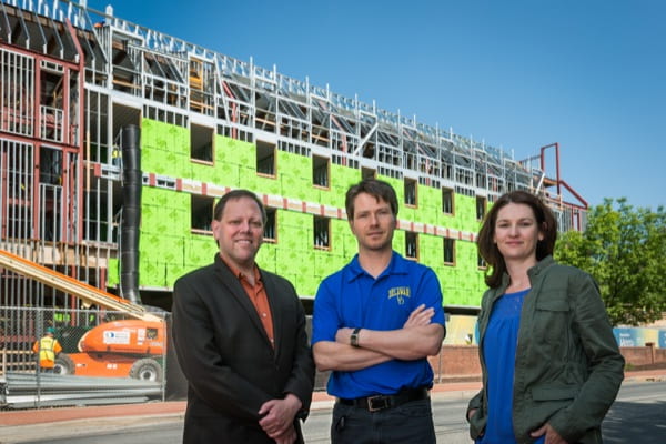 From left: Erik Thostenson, assistant professor of mechanical engineering; Thomas Schumacher, assistant professor of civil and environmental engineering; and Jennifer McConnell, associate professor of civil and environmental engineering, together near the construction of the new Academy Street Dining and Residence Hall (ASDR) for a UDaily article on monitoring the health of steel-framed buildings.