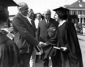 Warren G. Harding, President of the United States, congratulates Mary Haudy, a graduate of the Women''s College of Delaware, during commencement in 1923.