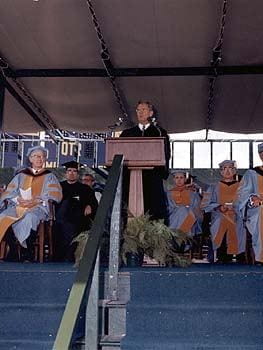William McChesney Martin, Chairman of United States Federal Reserve Board, speaks at the University of Delaware commencement ceremonies of 1970. Seated around him are members of the Board of Trustees and Edward A Trabant, the President of the University.