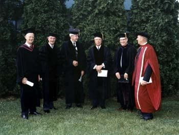 Three honorary degree recipients chat with members of the University of Delaware administration at the 1968 commencement. Pictured here from left to right are James M. Tunnell Jr. (President of the Board of Trustees), George P. Edmonds (an honorary degree recipient), William Maurice Ewing (an honorary degree recipient and commencement speaker), John Alanson Perkins (an honorary degree recipient and former President of the University), John W. Shirley (Acting President of the University), and Samuel Lenher (a member of the Board of Trustees).