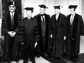 An informal photograph of five honorary degree recipients at the University of Delaware commencement in 1953. Pictured here from left to right are Albert E. Forster (the commencement speaker), Arthur R. McKinstry, John Alanson Perkins (President of the University), Amandus Johnson, and Victor D. Washburn.