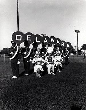 Posed Photograph of members from the University Delaware Marching Band. Photograph taken during 1964- 1965 academic year.