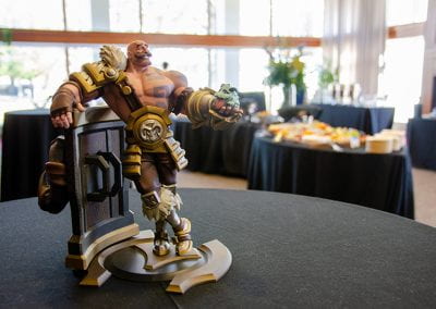 Statue of a video game character with catering tables in the background