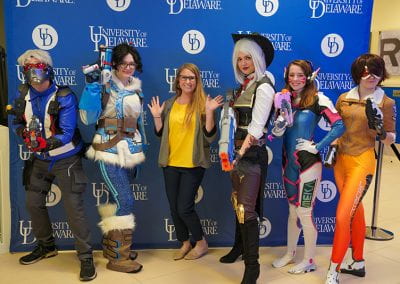 USC staff member poses with Overwatch cosplayers