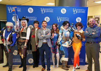 UD staff poses with Overwatch cosplayers