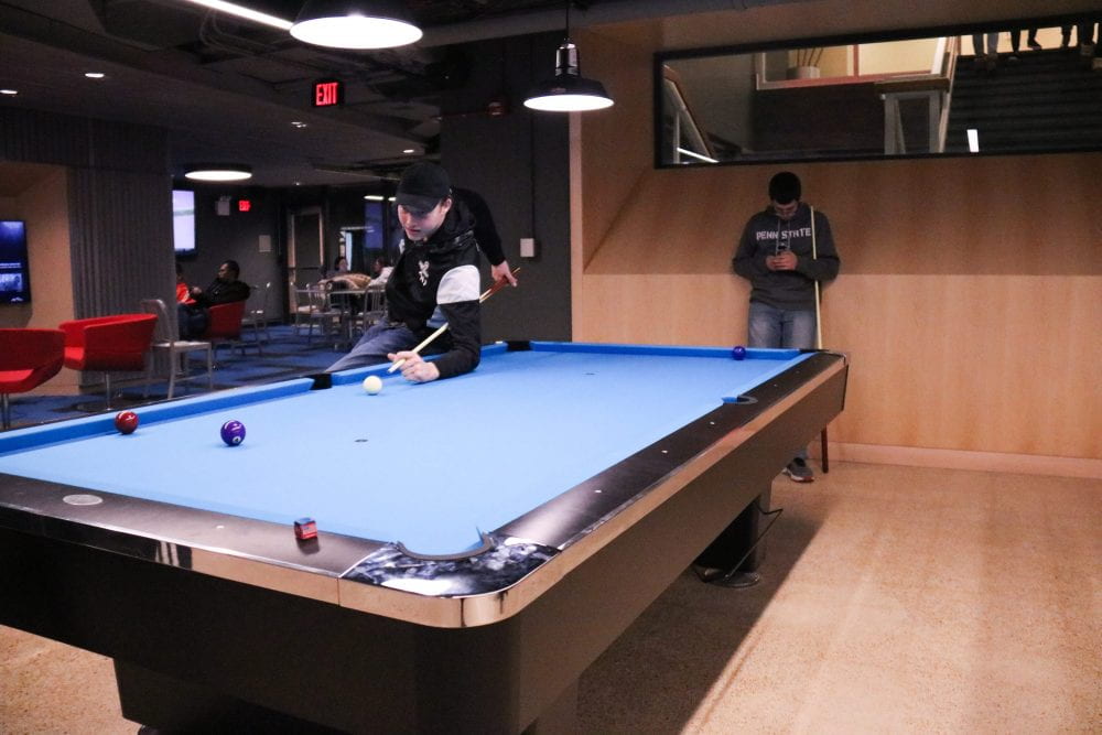 students playing pool in Hen Zone