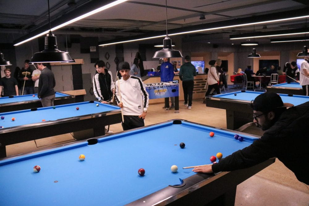 students playing pool in Hen Zone