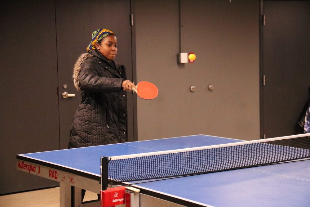 student playing table tennis in Hen Zone