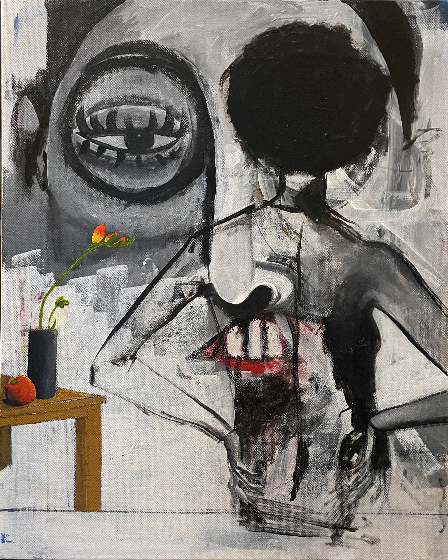 Black and white painting of female standing in front of a large face in the background, visible through her opaque figure. Pops of color appear throughout the artwork in an orange and flower on a table and the mouth of the face.