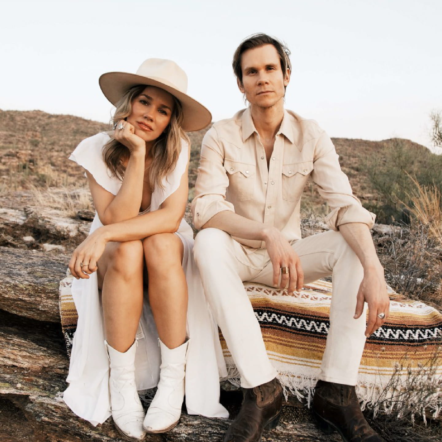 Lance and Lea pose on a southwestern blanket in a desert scene
